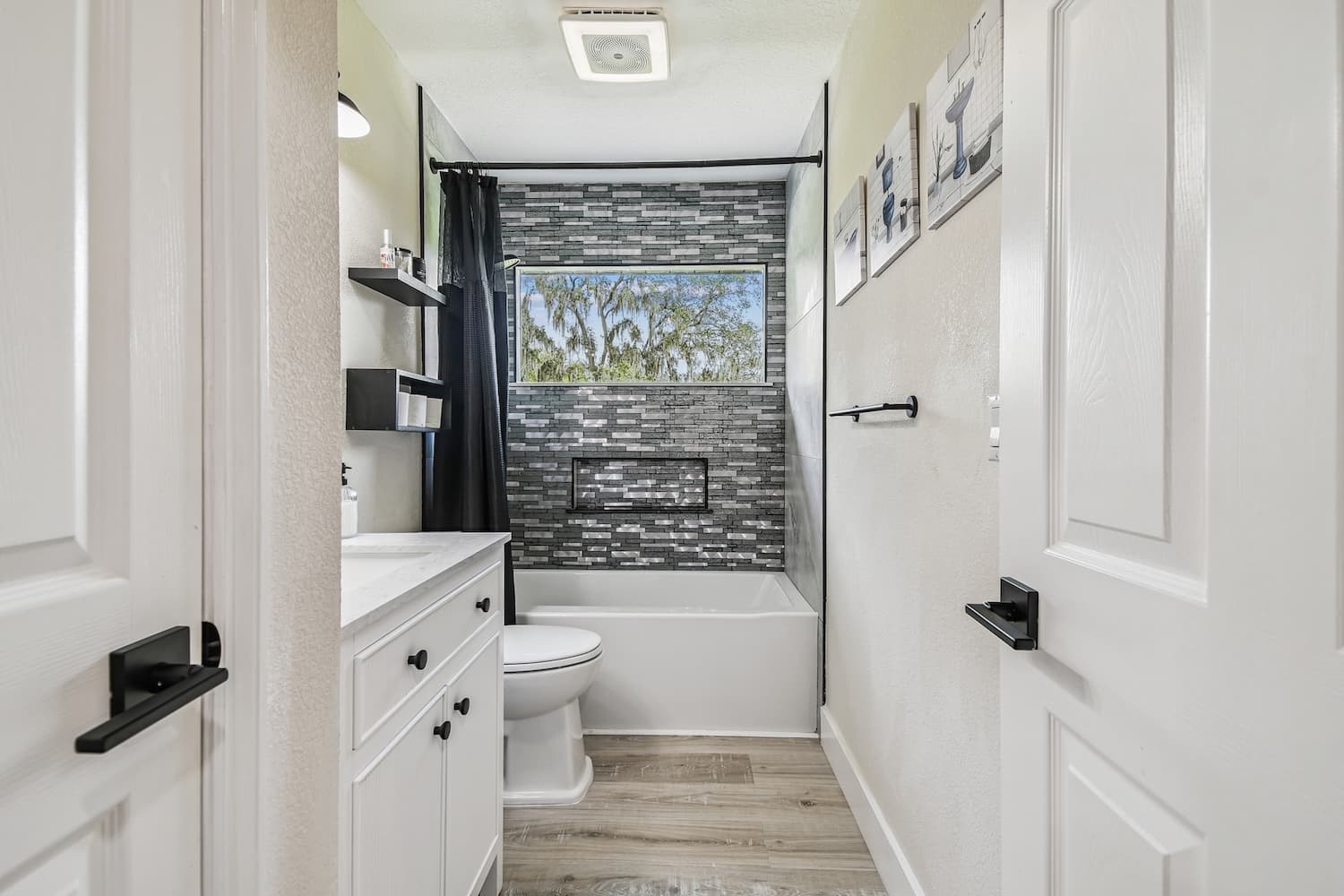 Bathroom with stacked gray tile tub surround