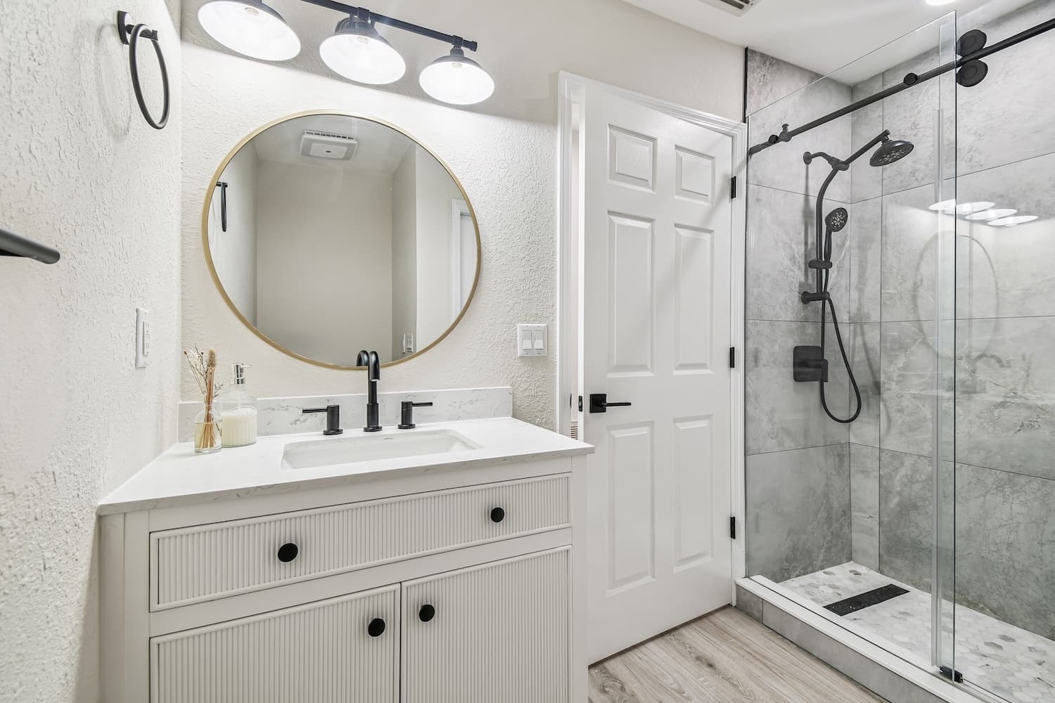 Bathroom with white vanity and glass shower enclosure