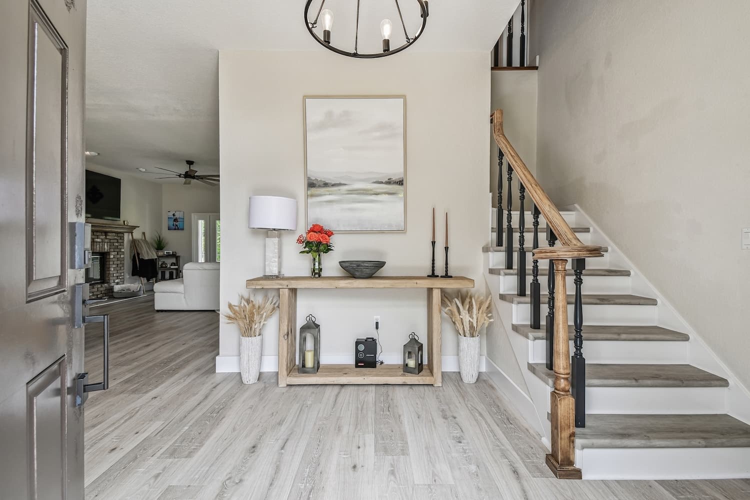 Tampa whole home renovation with custom staircase, iron balusters, and orb chandelier