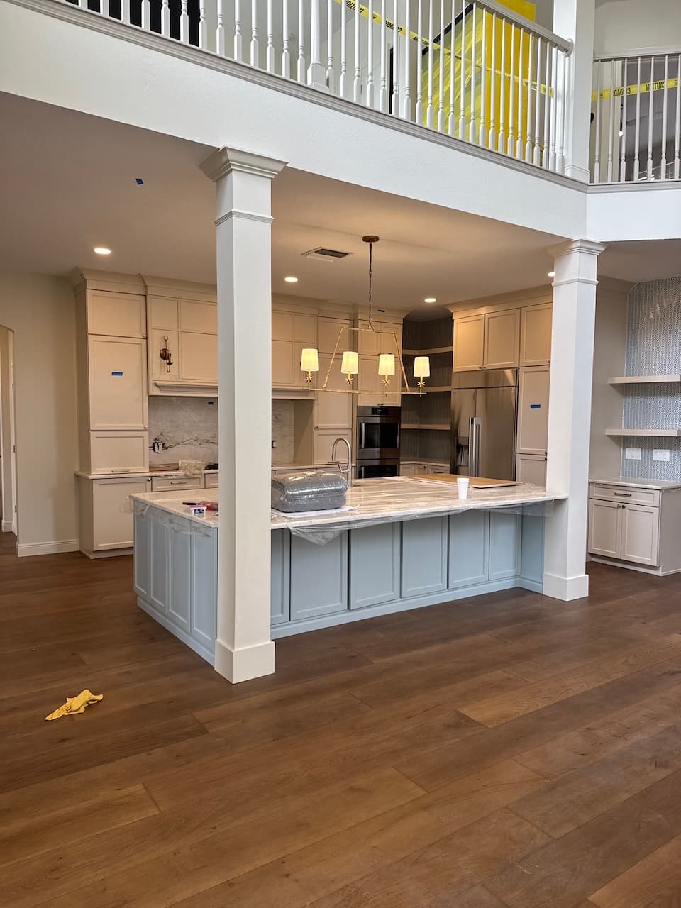 Open concept kitchen remodel with island and columns in Tampa