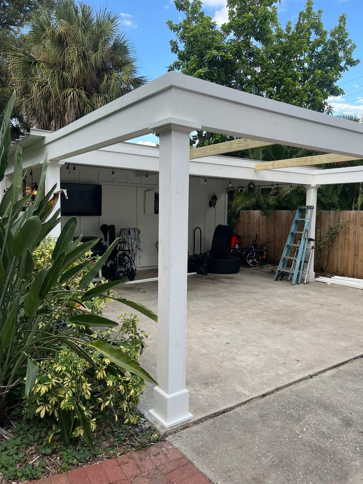 Carport renovation with white columns during construction in Tampa