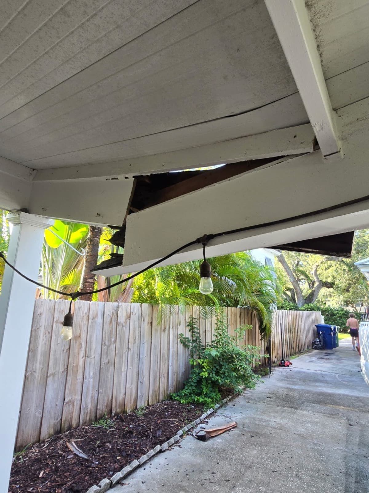 Carport roof damage before restoration in Tampa