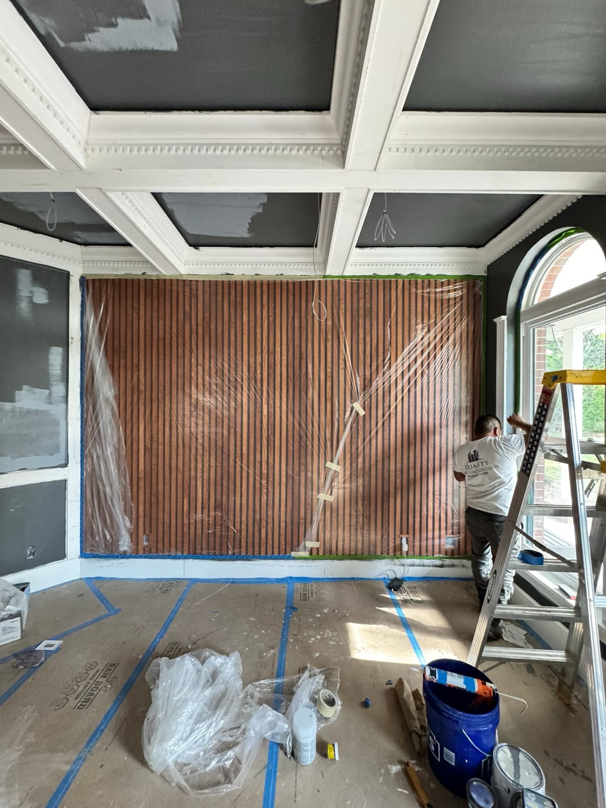 Coffered ceiling and slat wall painting in progress in Tampa