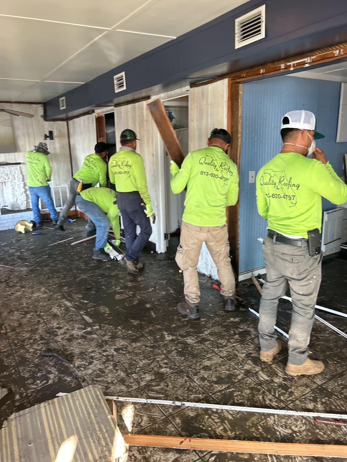 Restoration crew performing flood damage demolition in Tampa