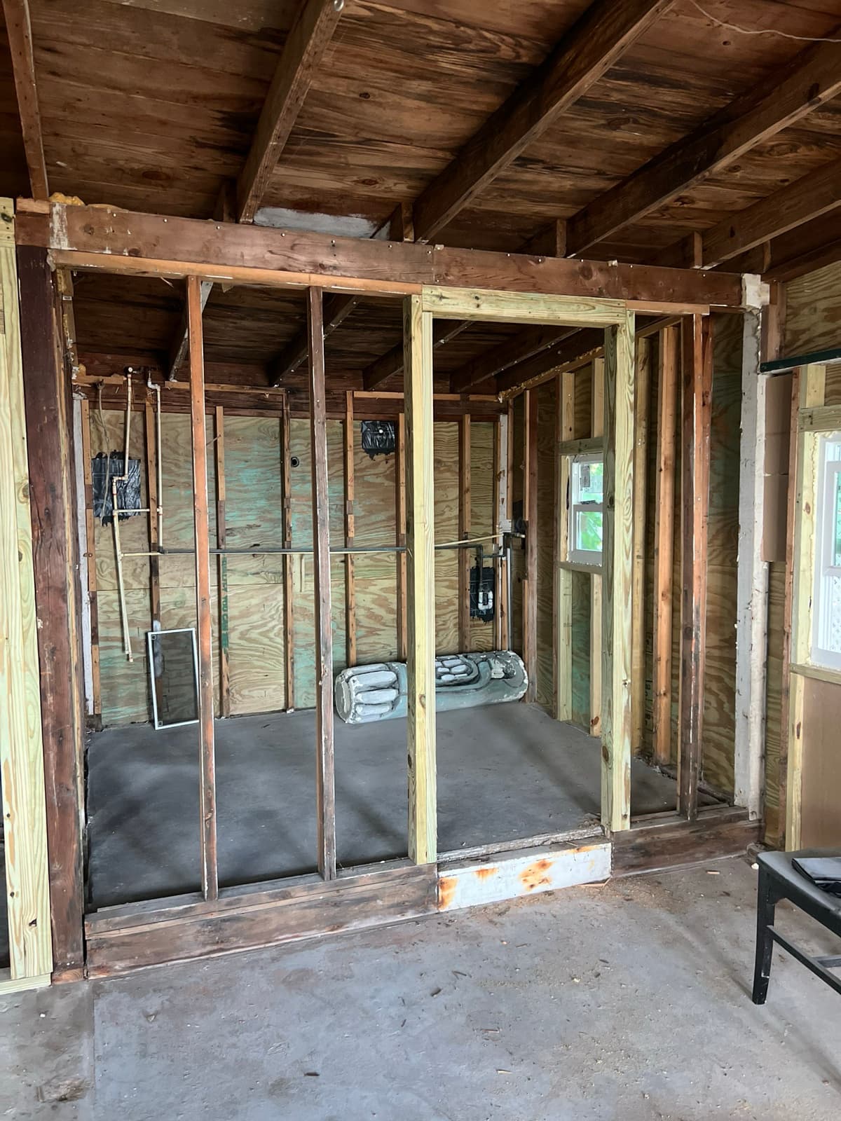 Tampa interior reconstruction in progress following water damage, with new framing and electrical rough-in after demolition