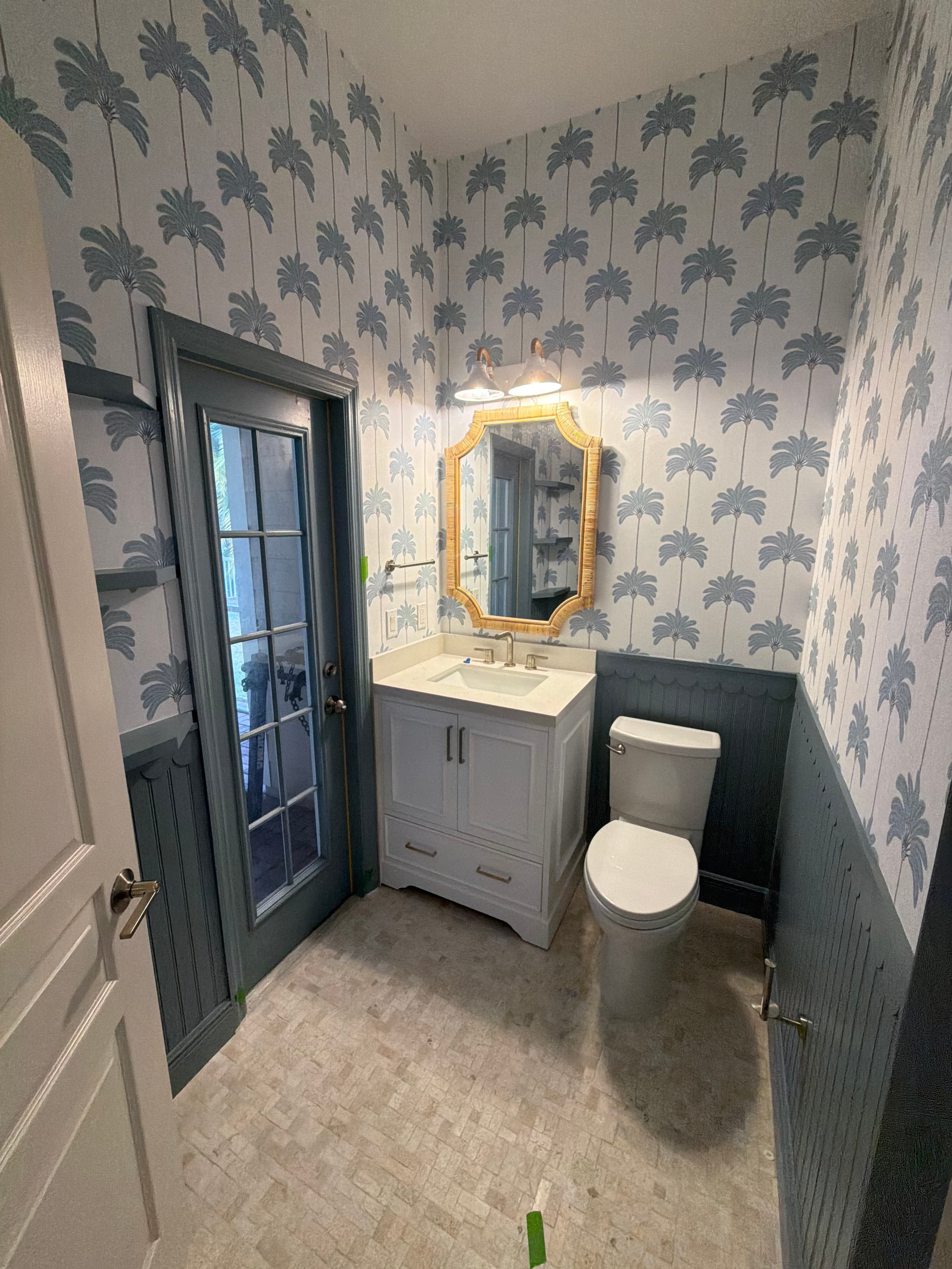 Powder room with palm wallpaper in Tampa